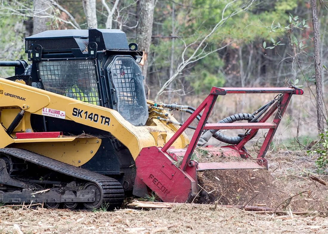 front loader and truck excavating land