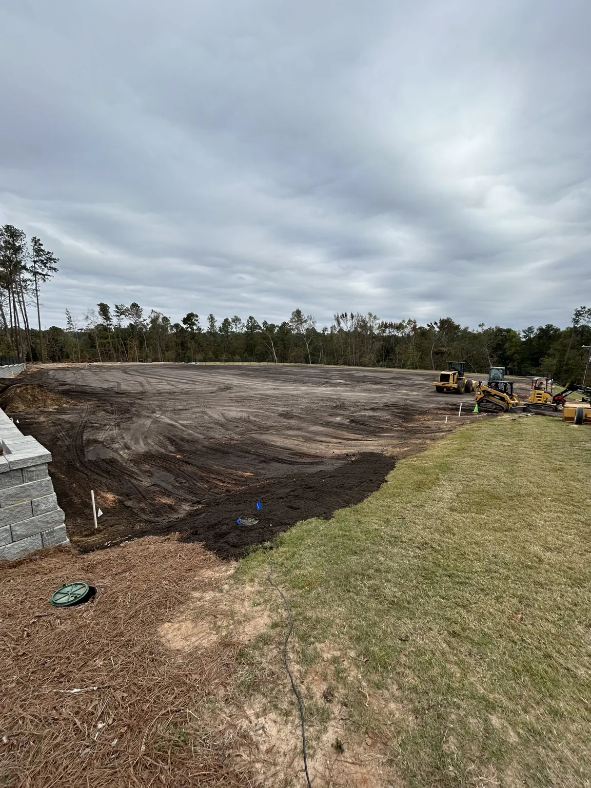Contractor equipment working after topsoil installation
